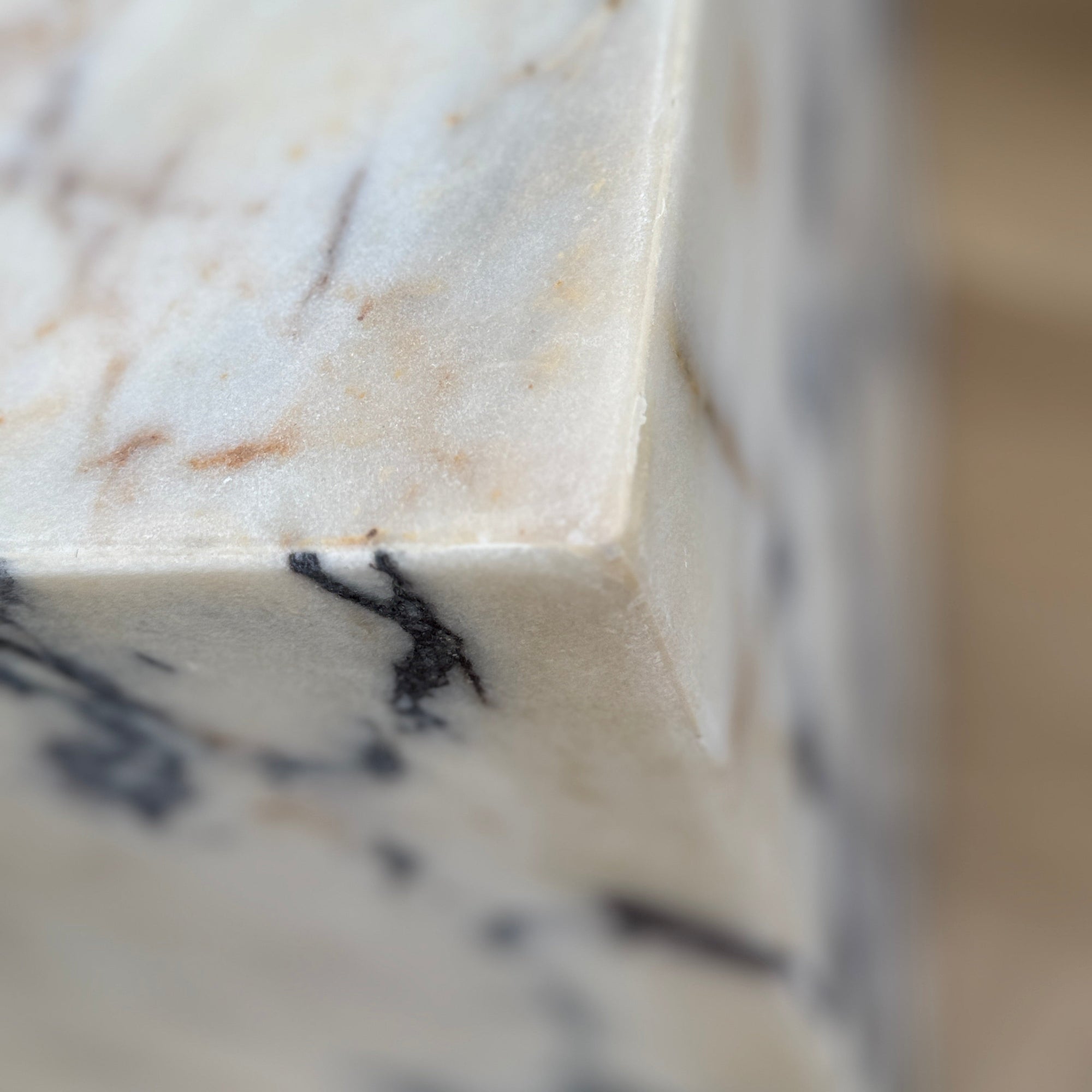 Close-up of a marble countertop with a blurred background